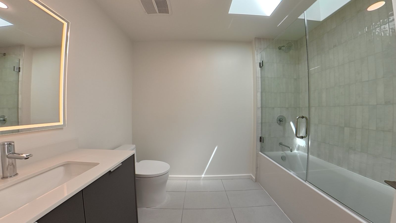 Spa-inspired bathroom with frameless glass shower and soaking tub
