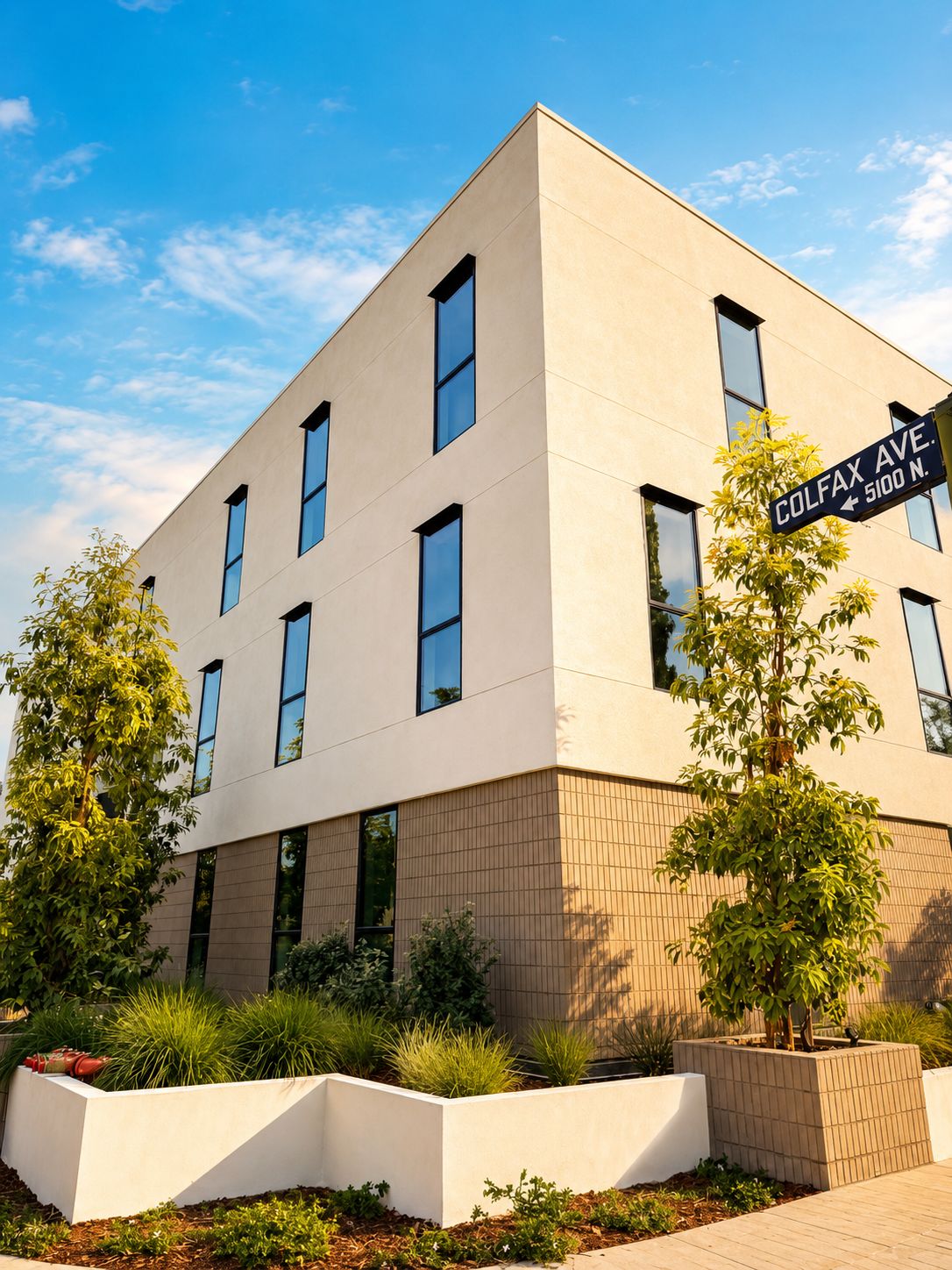 The building's corner at Colfax Avenue under a blue sky